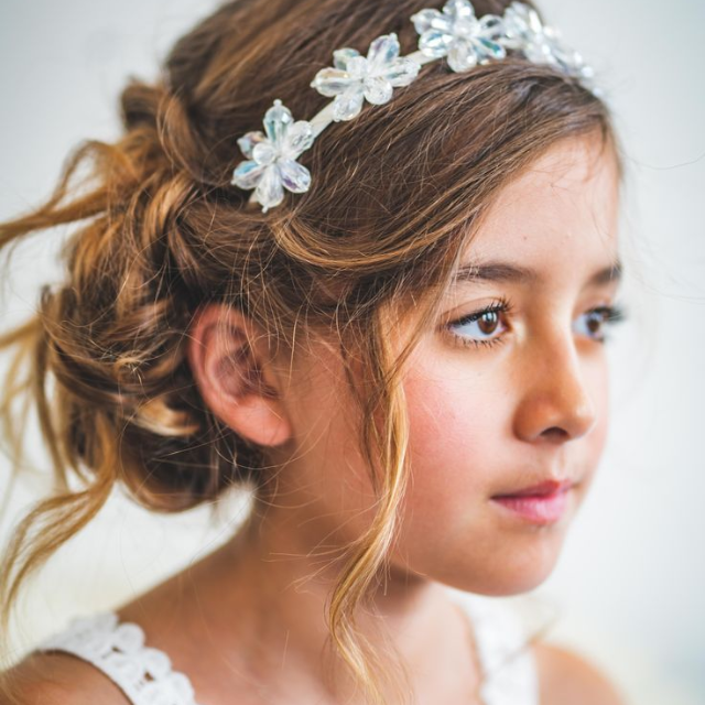A charming girl with double dutch braids adorned with a stylish headband