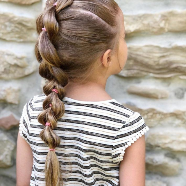 Adorable pigtail braids with colorful ribbons, adding a playful touch to a child's hairstyle